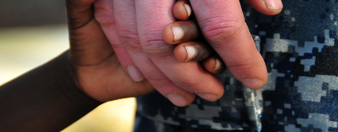One hand holding another